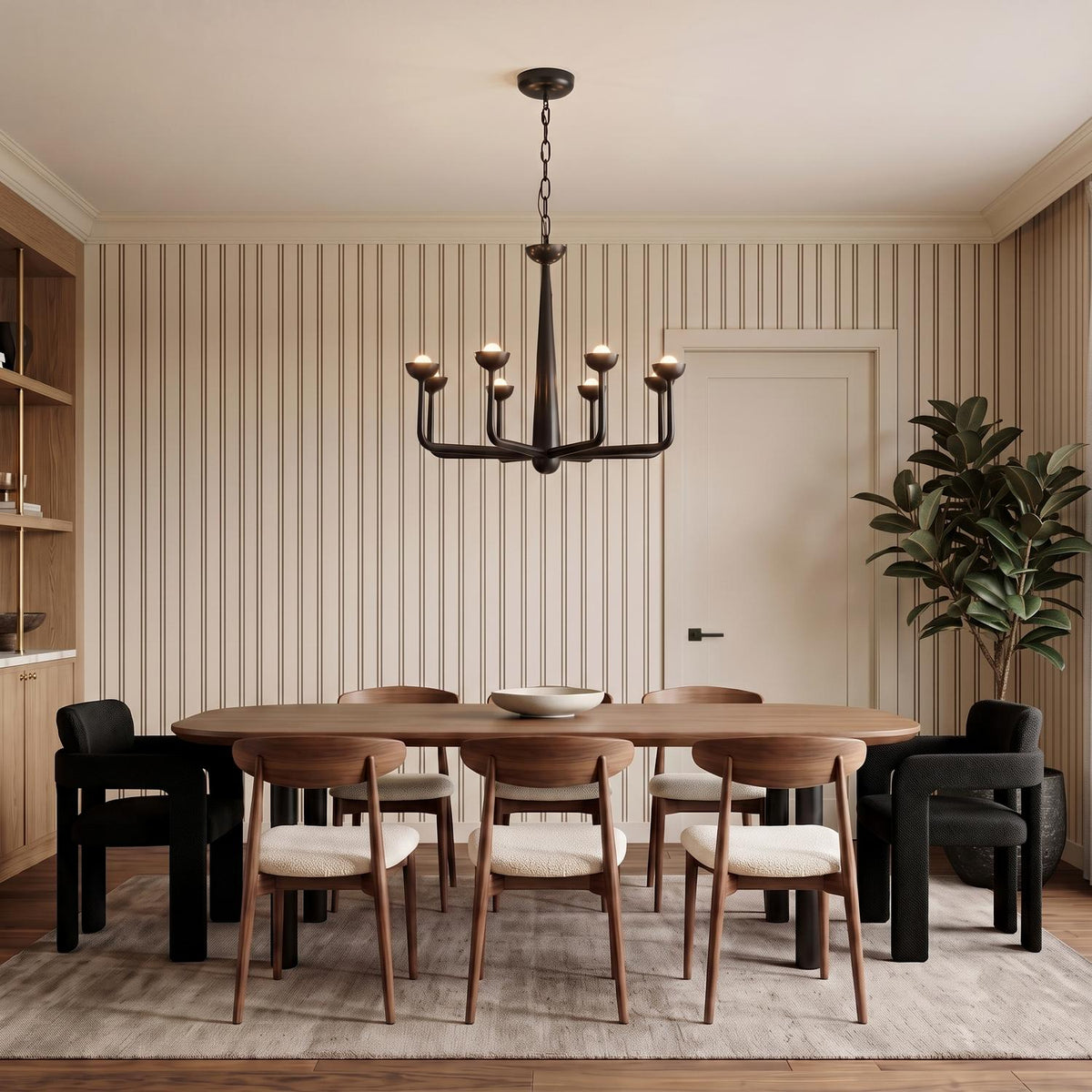 A transitional dining room with the Bettina LED Chandelier 30", Urban Bronze over a walnut dining table featuring vertical striped wallpaper and mid-century walnut chairs.