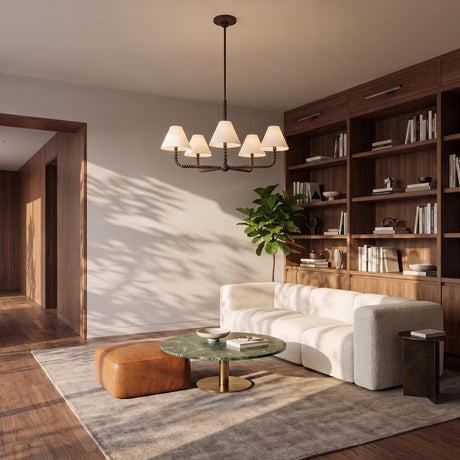 A mid-century living room with the Casimir 5 Light Chandelier in Aged Iron and white linen shades suspended over a green marble coffee table and walnut shelving.