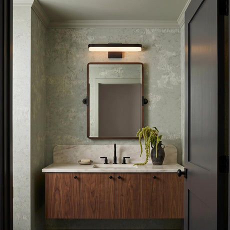 A contemporary bathroom featuring the Harbor LED Vanity Light 18", Matte Black over a rectangular mirror above a white marble countertop and floating walnut vanity.