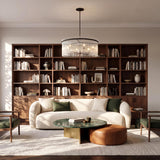 A mid-century living room featuring the Marcella 6 Light Chandelier 36", Matte Black with glass rods over a green marble coffee table and cream bouclé sofa.