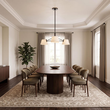 A contemporary dining room featuring the Barton 3 Light Chandelier in aged iron and white linen shades over a walnut table under a coffered ceiling.