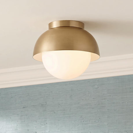 A transitional foyer featuring the Morrison Small Flush Mount 8 inch in satin brass and opal glass along the ceiling center above blue textured grasscloth wallpaper.
