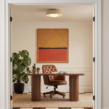 A mid-century office featuring the Stratford Medium Flush Mount in aged brass and beige centered above a walnut desk, tufted leather chair, and checkered flooring.