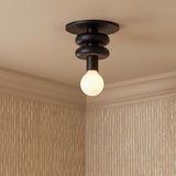 A contemporary foyer with the Filomena Extra Small Flush Mount 5, Matte Black along the ceiling near textured beige wallpaper and white crown molding.