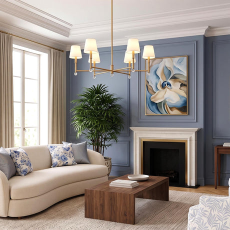 A transitional living room with the Savannah 6 Light Chandelier 40", Gilded Brass with linen shades centered over a cream sofa and a white marble fireplace.