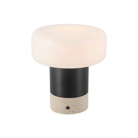 Ralston Rechargeable Table Lamp 7", Urban Bronze and Travertine, angled view, lit frosted drum shade above Travertine base