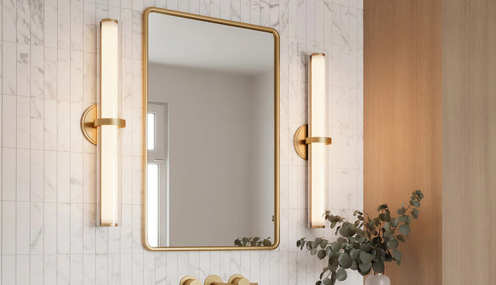 Bathroom lighting with tall LED wall sconces in brass