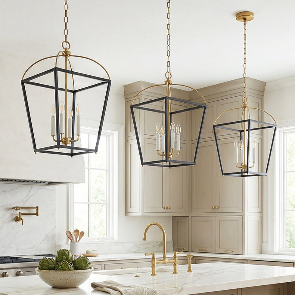 Three Langford Large Lantern Pendant hanging lights in Black and Satin Brass in a large transitional kitchen with taupe custom cabinetry and marble slab counters.
