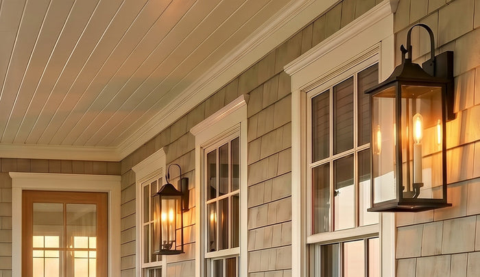 Two Lorraine Outdoor Wall Lights shown on a coastal home under a front porch with cedar shake siding.