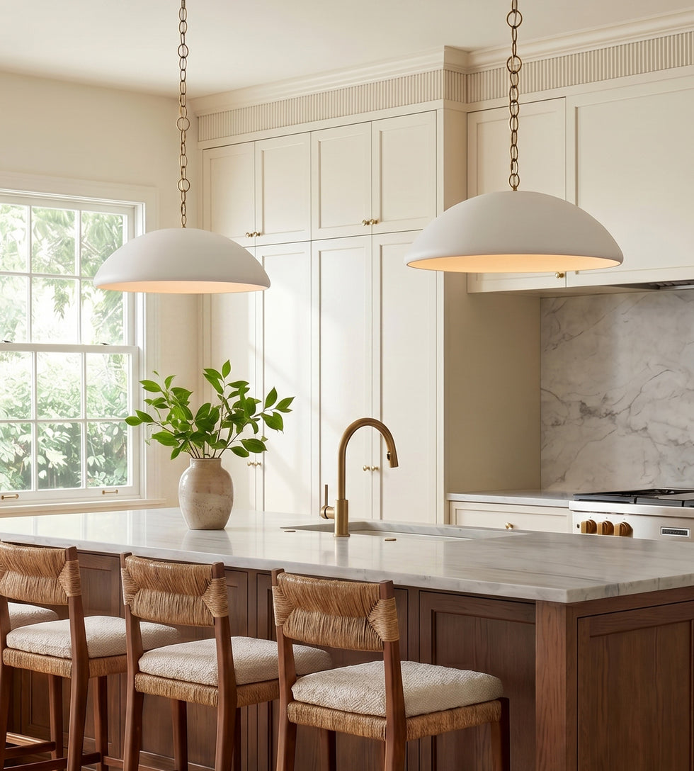 Two Charlie Pendants 28" wide, in Matte White and Brushed Brass chains hung in a bright transitional kitchen with large island.