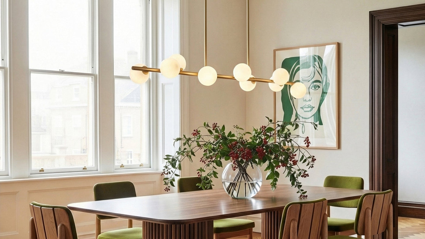 Veya 9 Light Modern Linear Chandelier hung in a classic dining room with mid-century modern design, green velvet chairs, and modern art.